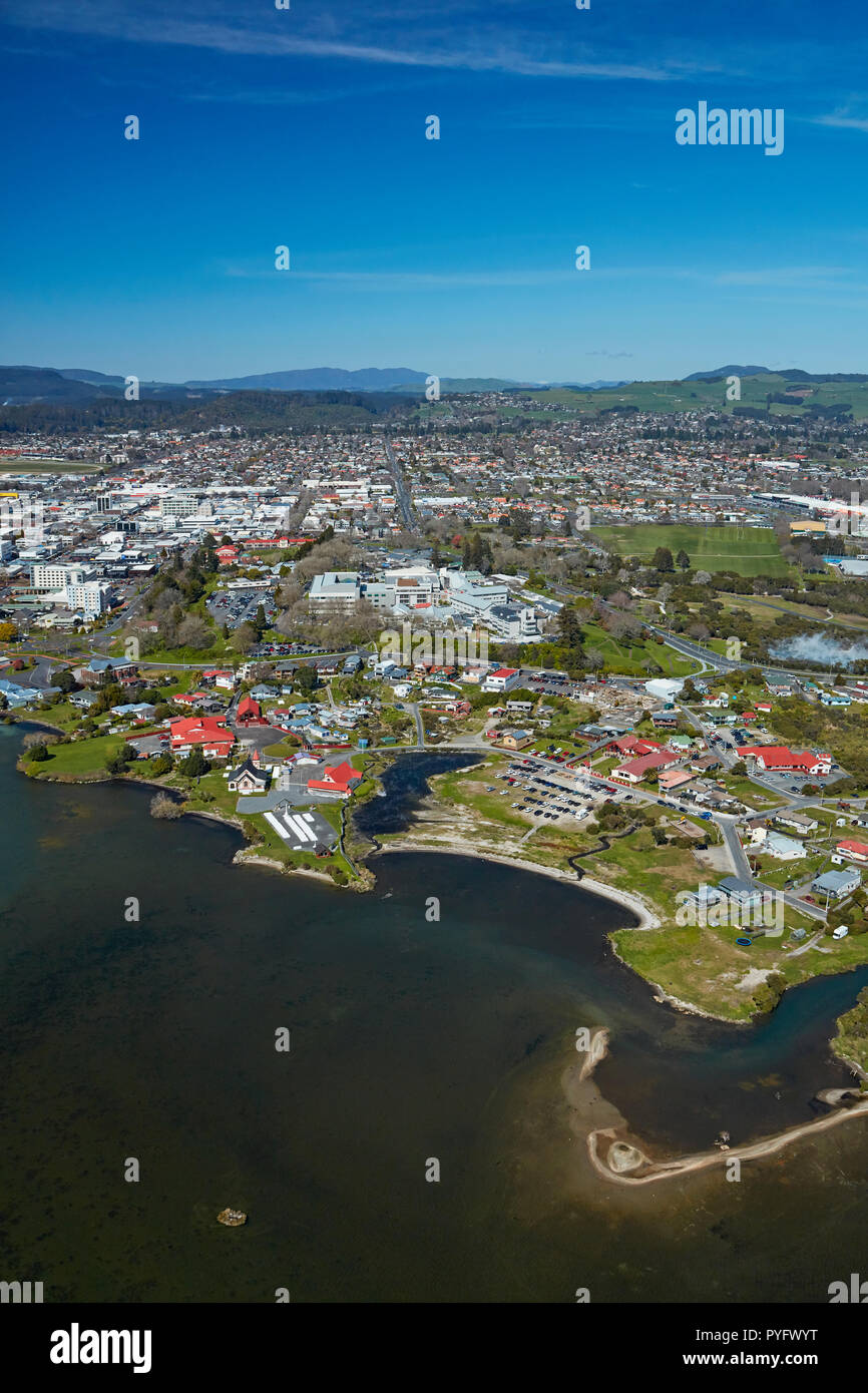 Lake Rotorua, Ohinemutu Maori Village, and city centre, Rotorua, North Island, New Zealand - aerial Stock Photo