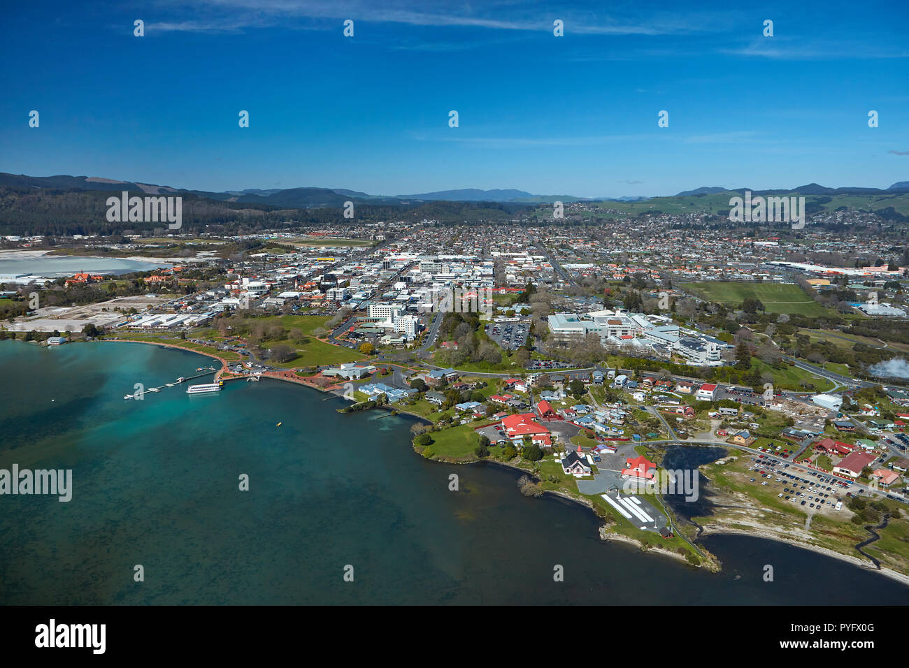Ohinemutu Maori Village, Lake Rotorua, waterfront, and city centre, Rotorua, North Island, New Zealand - aerial Stock Photo