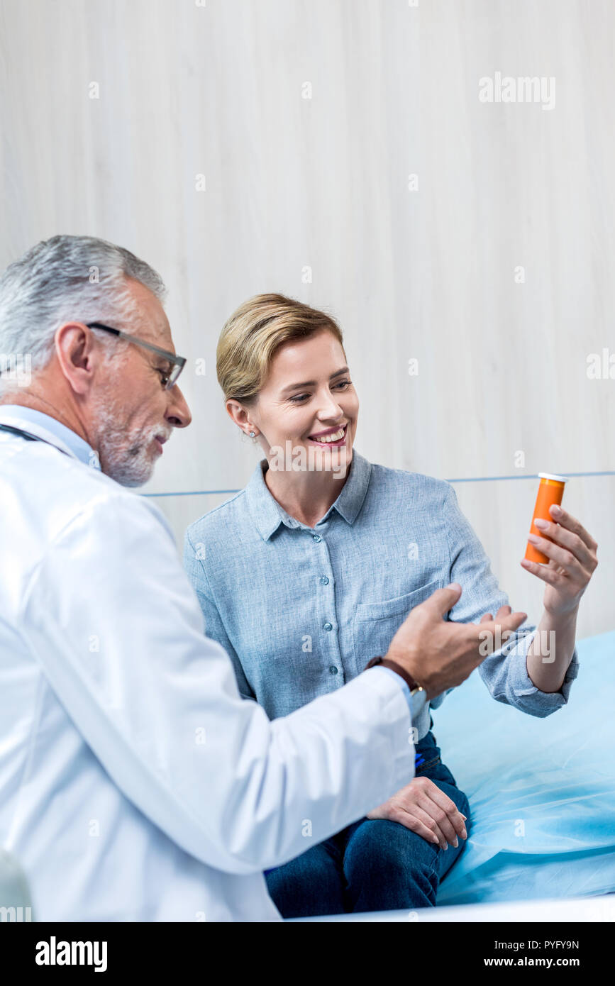 Doctor giving prescription smiling woman hi-res stock photography and ...