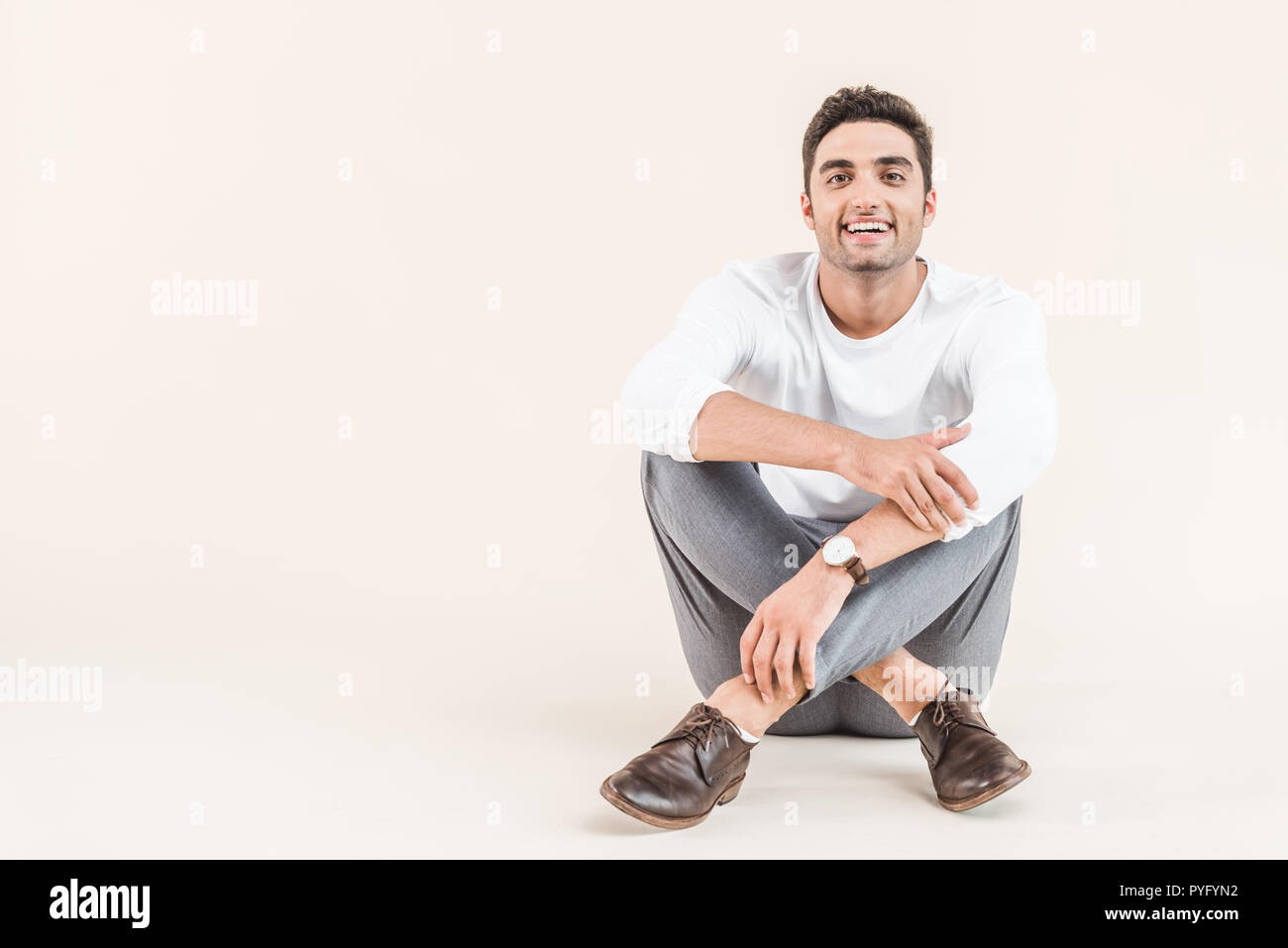 Cheerful young man sitting hi-res stock photography and images - Alamy