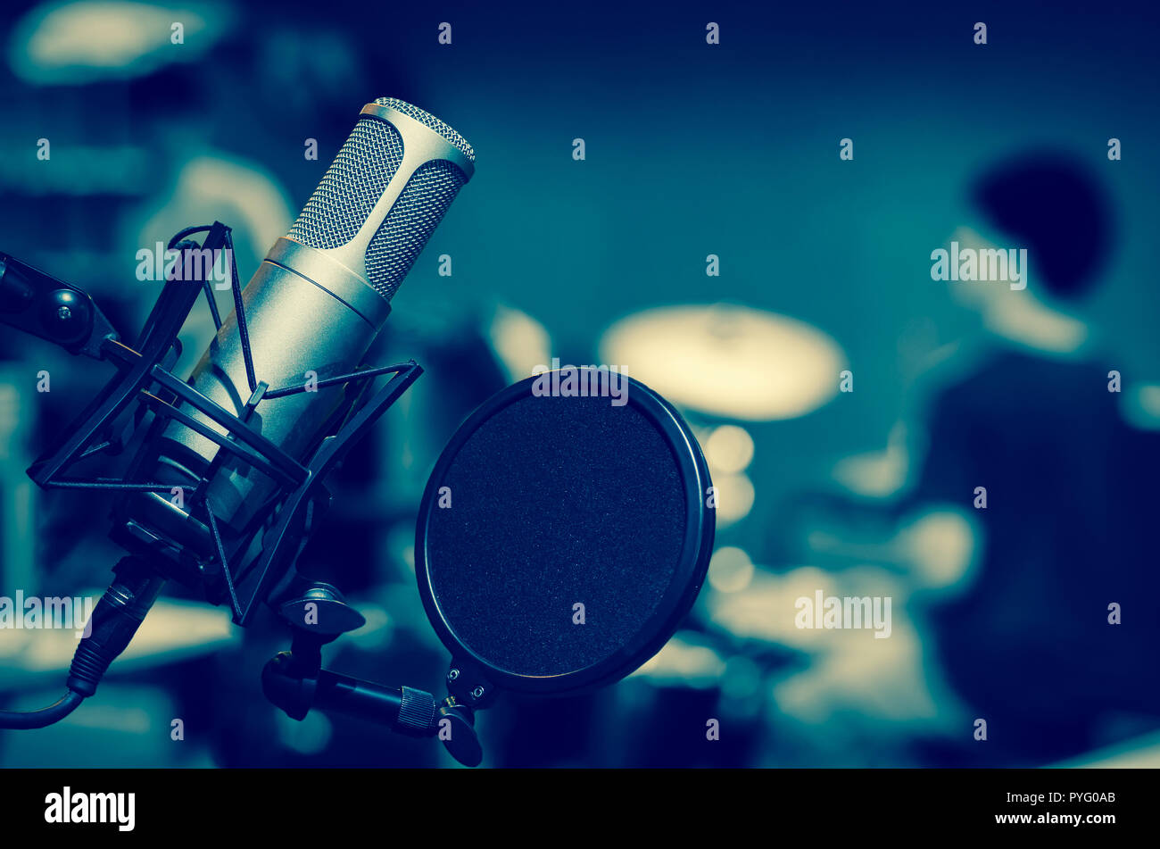 Professional studio microphone over music studio Stock Photo by