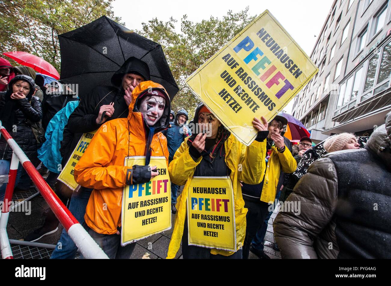 Munich, Bavaria, Germany. 27th Oct, 2018. Counter-demonstrators against Pegida using the ''Neuhausen Pfeift'' action signs. Attempting to draw more followers and expand PEGIDA into Bavaria, "Pegida Dresden"" announced an appearance by founders LUTZ BACHMANN and SIEGFRIED DAEBRITZ in Munich's Neuhausen district. Ultimately, the two did not arrive, leaving approximately 40 Pegida followers to march against over 450 counter-demonstrators. Pegida Dresden in Munich is actually Pegida Nuremburg who is attempting to expand south to Munich where the rival Pegida Muenchen is already active. Stock Photo