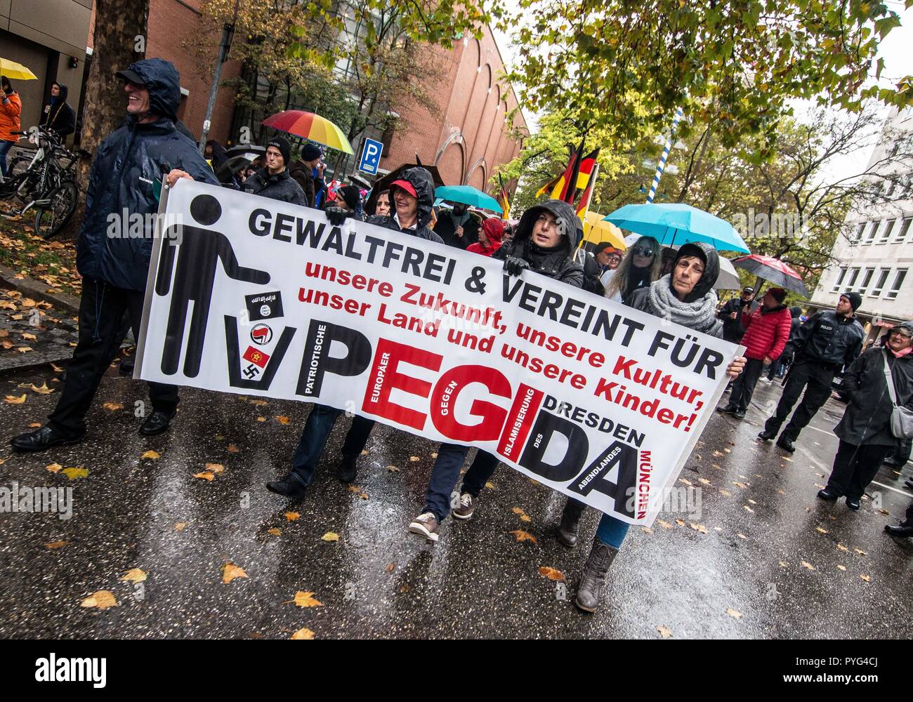 Munich, Bavaria, Germany. 27th Oct, 2018. Pegida marchers in Munich hold a banner. Attempting to draw more followers and expand PEGIDA into Bavaria, "Pegida Dresden"" announced an appearance by founders LUTZ BACHMANN and SIEGFRIED DAEBRITZ in Munich's Neuhausen district. Ultimately, the two did not arrive, leaving approximately 40 Pegida followers to march against over 450 counter-demonstrators. Pegida Dresden in Munich is actually Pegida Nuremburg who is attempting to expand south to Munich where the rival Pegida Muenchen is already active. The latter group is more closely associa Stock Photo