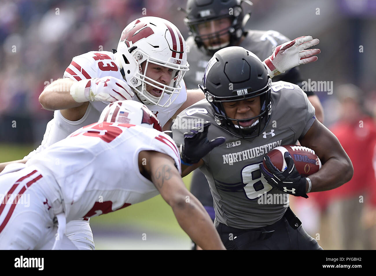 Evanston, Illinois, USA. 27th Oct, 2018. Northwestern Wildcats wide receiver Kyric McGowan (8) is tackled by Wisconsin Badgers linebacker Ryan Connelly (43) and Wisconsin Badgers safety Eric Burrell (25) in the first half. Credit: Quinn Harris/ZUMA Wire/Alamy Live News Stock Photo