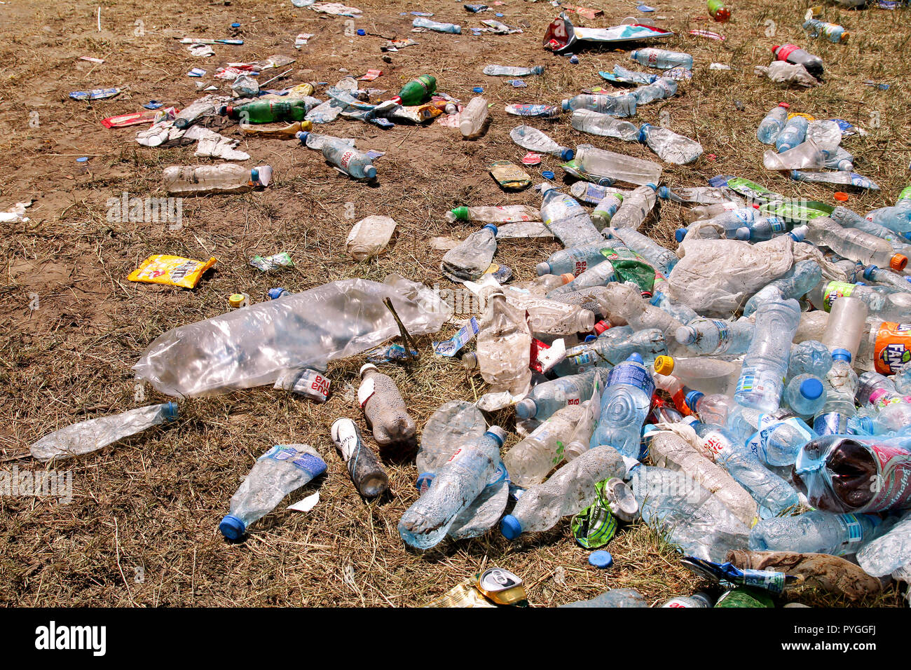 Belgrade, Serbia - June 25, 2017: Plastic pet bottles left on grass after an party, event. Used empty bottles thrown away on the ground after an open. Stock Photo