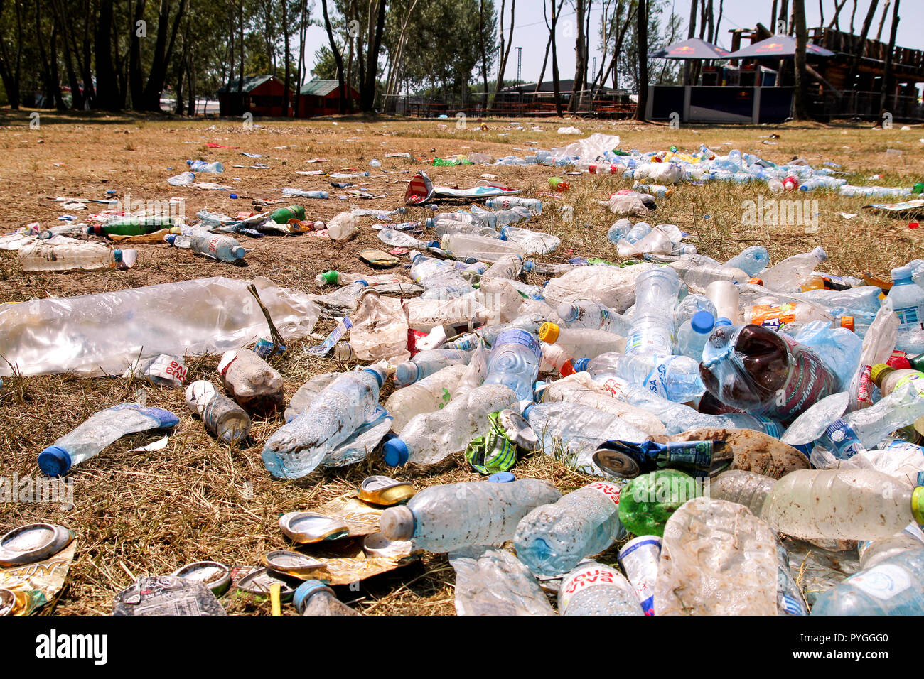 Belgrade, Serbia - June 25, 2017: Plastic pet bottles left on grass after an party, event. Used empty bottles thrown away on the ground after an open. Stock Photo