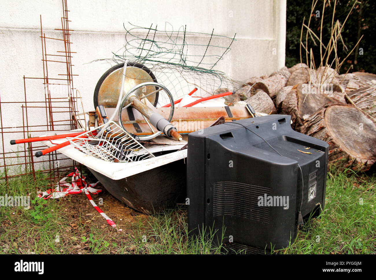 Old TV set and the rest of bulky trash. Old TV thrown away next to a