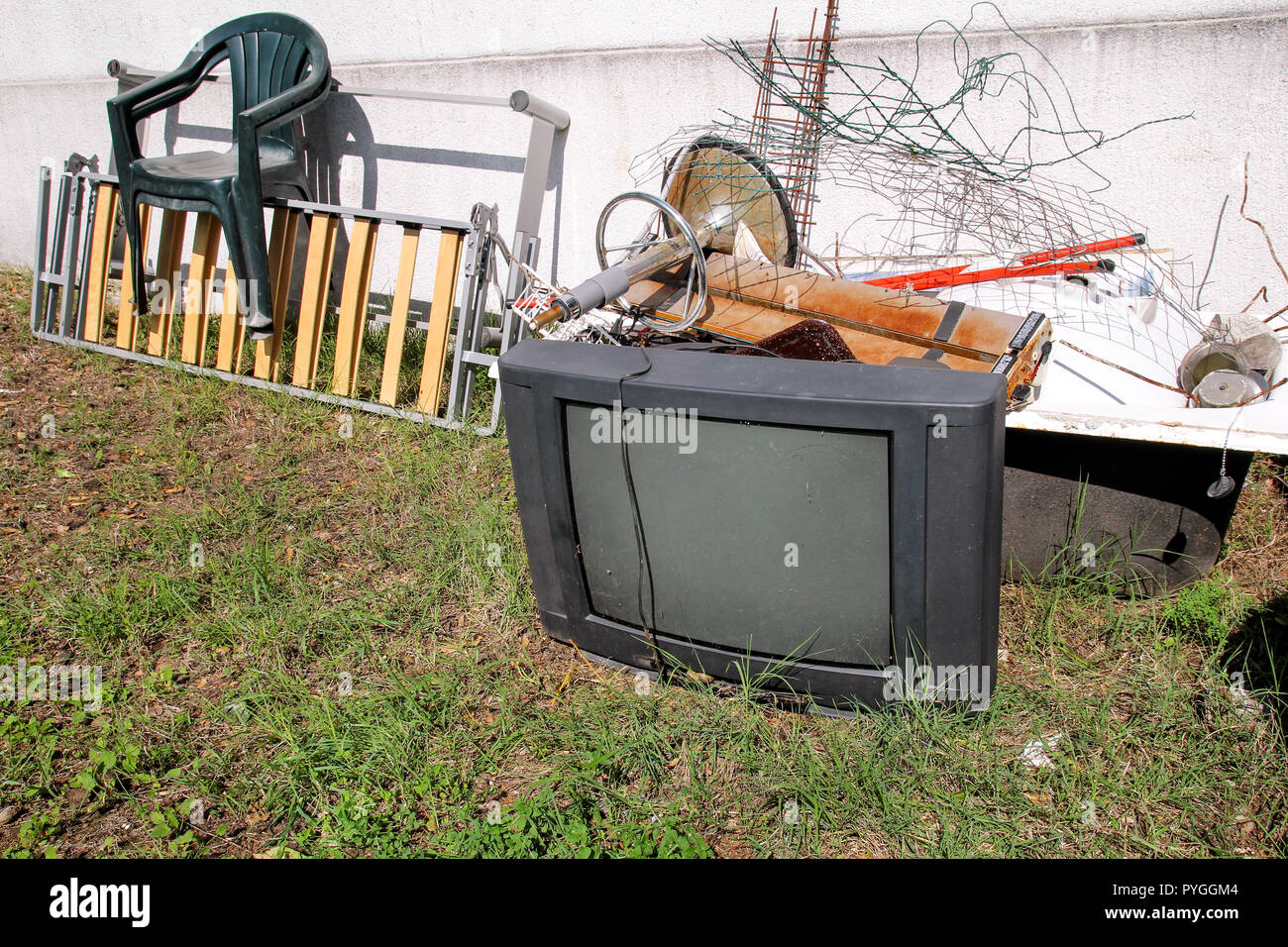 Old TV set and the rest of bulky trash. Old TV thrown away next to a