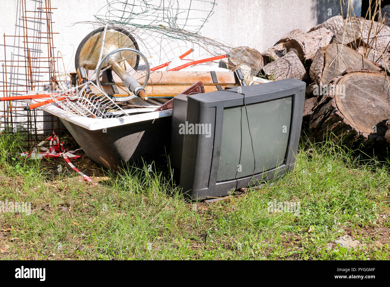 Old TV set and the rest of bulky trash. Old TV thrown away next to a