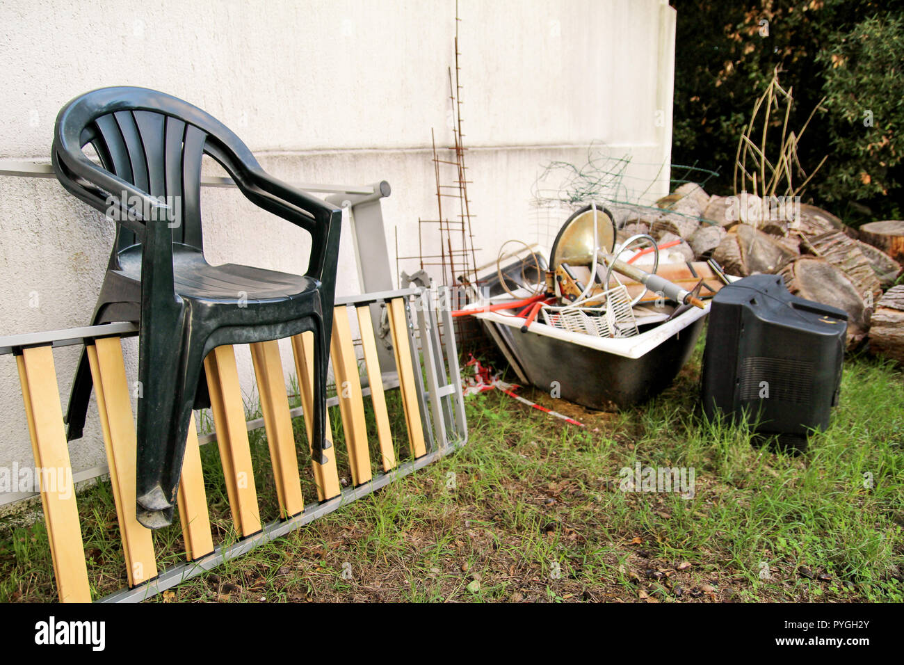 Old TV set and the rest of bulky trash. Old TV thrown away next to a