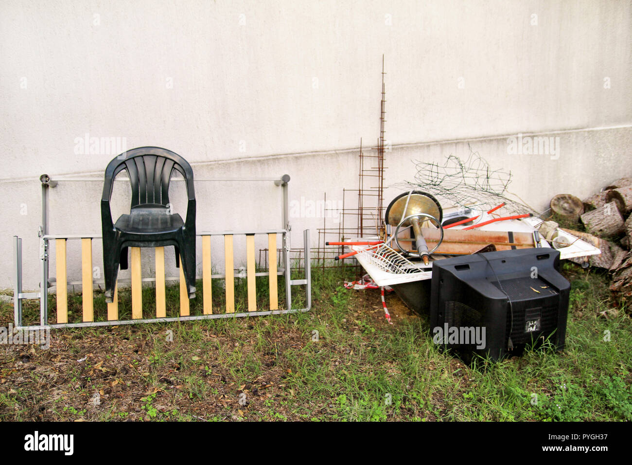 Old TV set and the rest of bulky trash. Old TV thrown away next to a