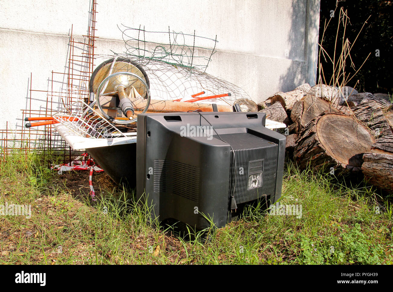Old TV set and the rest of bulky trash. Old TV thrown away next to a