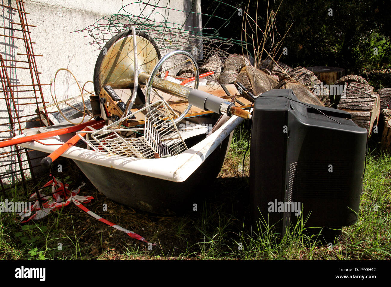 Old TV set and the rest of bulky trash. Old TV thrown away next to a