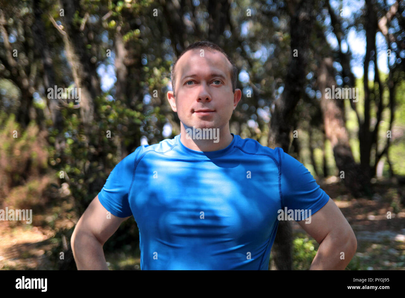 Handsome young muscular man wearing sportswear posing, portrait and enjoy  sunny day in beautiful landscape nature outdoor. Pretty guy, active Stock  Photo - Alamy