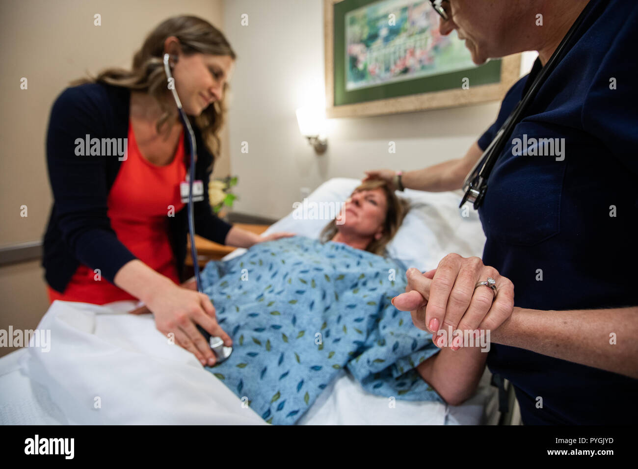 Doctor and nurse care for a patient in a hospice hospital. Stock Photo