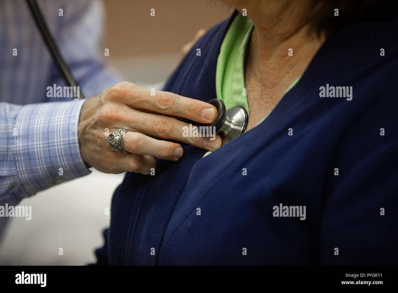 Doctor examines a patient with stethoscope Stock Photo - Alamy