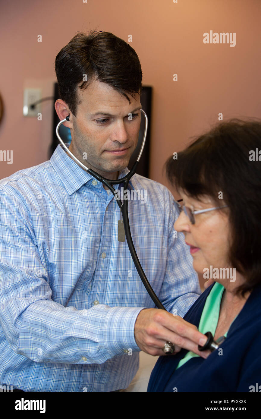 Doctor examines a patient with stethoscope Stock Photo - Alamy