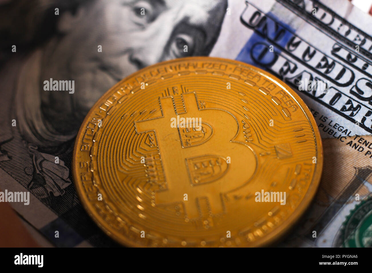golden bitcoin coin on us dollars. Cryptocurrency business concept background Stock Photo