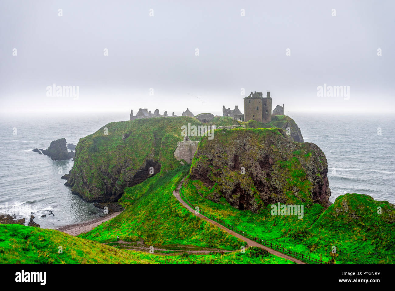 A view of scenic Dunnotar Castle on Scottish coastline with poor autumn weather and stormy North Sea, Aberdeenshire, Scotland Stock Photo