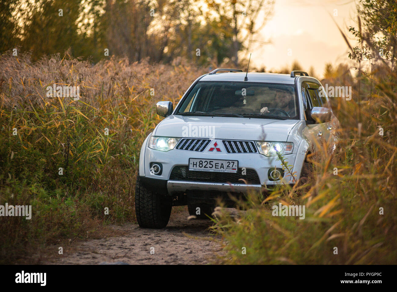 Mitsubishi Pajero Sport and trees in autumn on a sunny day. Khabarovsk, Russia. October 12, 2018 Stock Photo