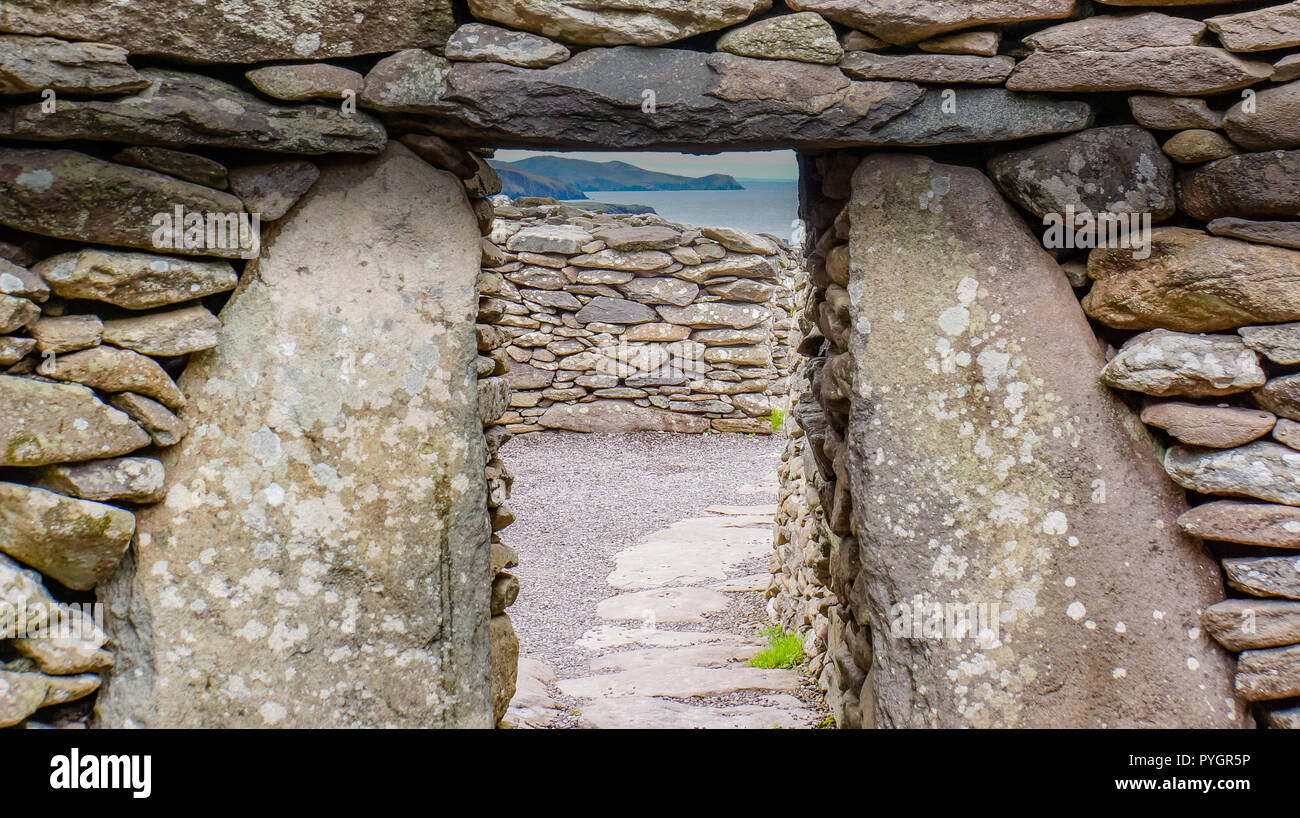 looking through a doorway of an ancient beehive Irish hut formed in stone cashels or enclosed farmsteads in the Early Christian Period Stock Photo