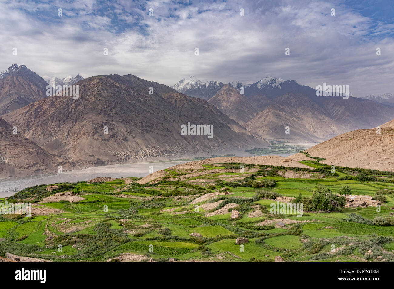Engels Peak Meadows trailhead view of Hindu Kush and green village of Dirch, Langar, Tajik Wakhan, Tajikistan Stock Photo