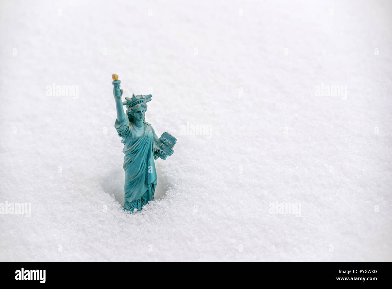 Statue of Liberty miniature in the snow. Winter snowfall in New York concept Stock Photo