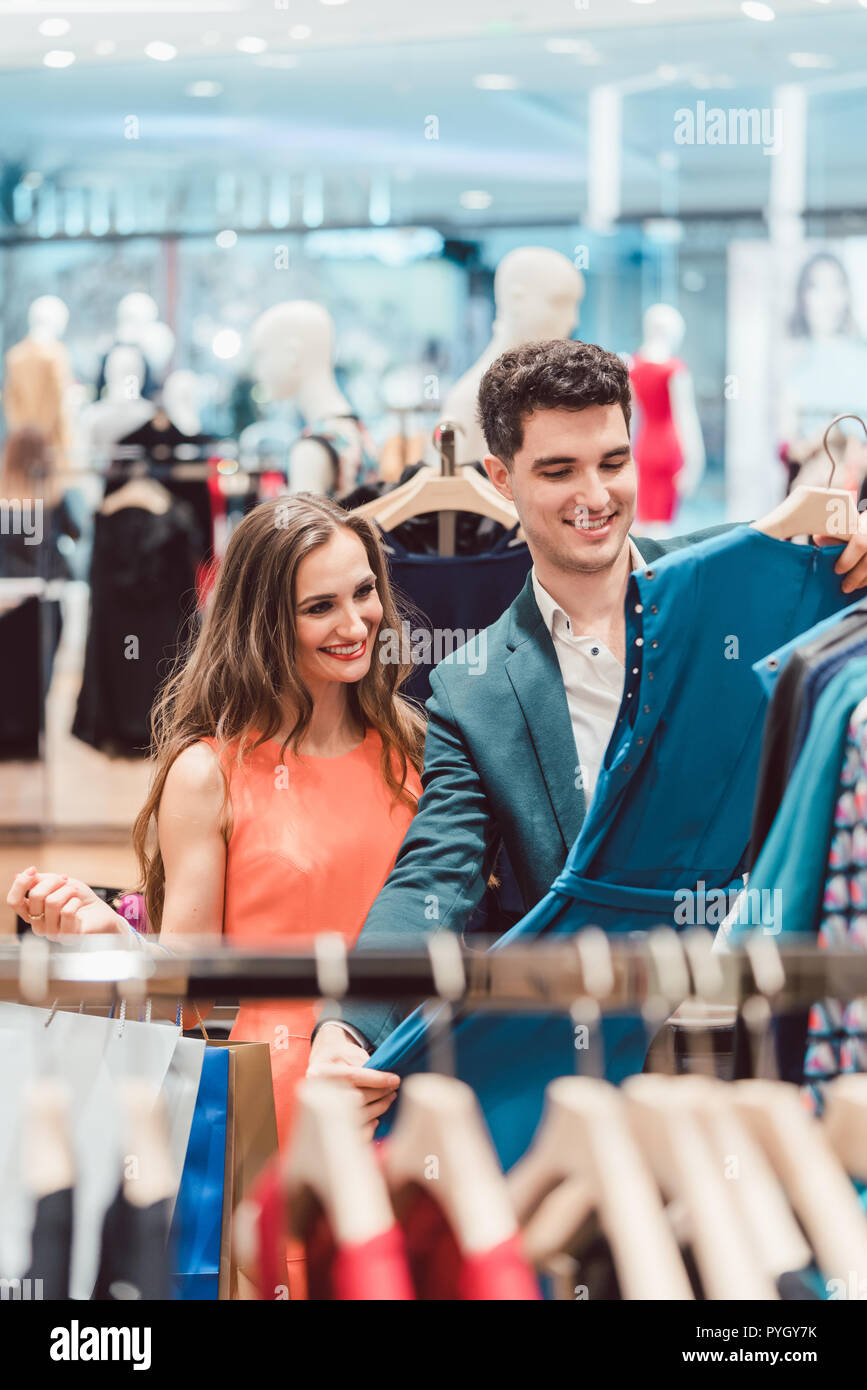 Couple shopping for fashion items in high end boutique Stock Photo