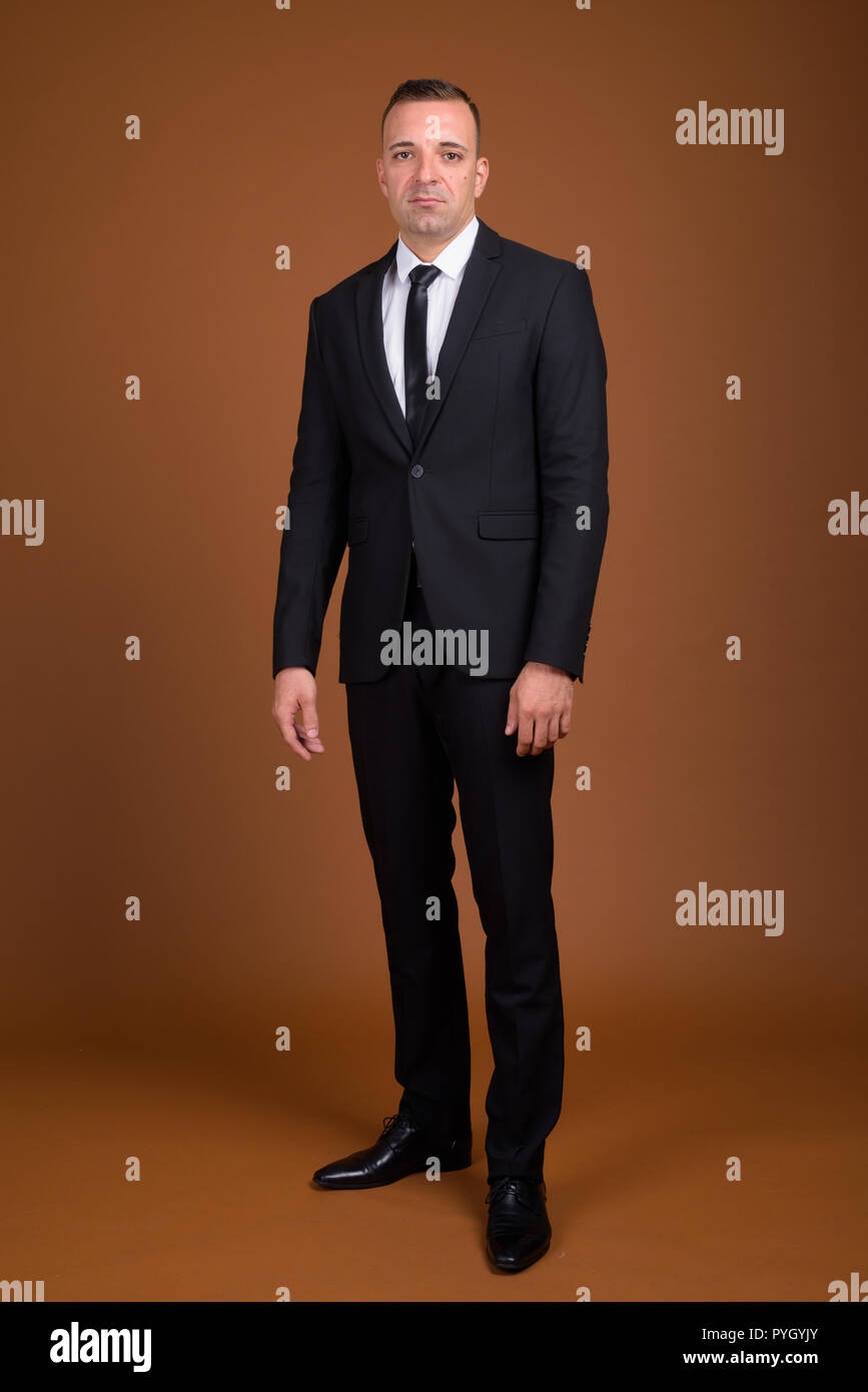 Full length shot of businessman standing and wearing suit Stock Photo