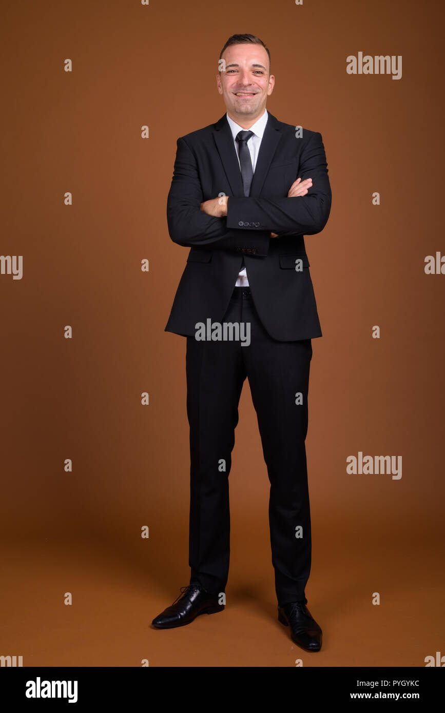 Full length shot of businessman standing and wearing suit Stock Photo ...