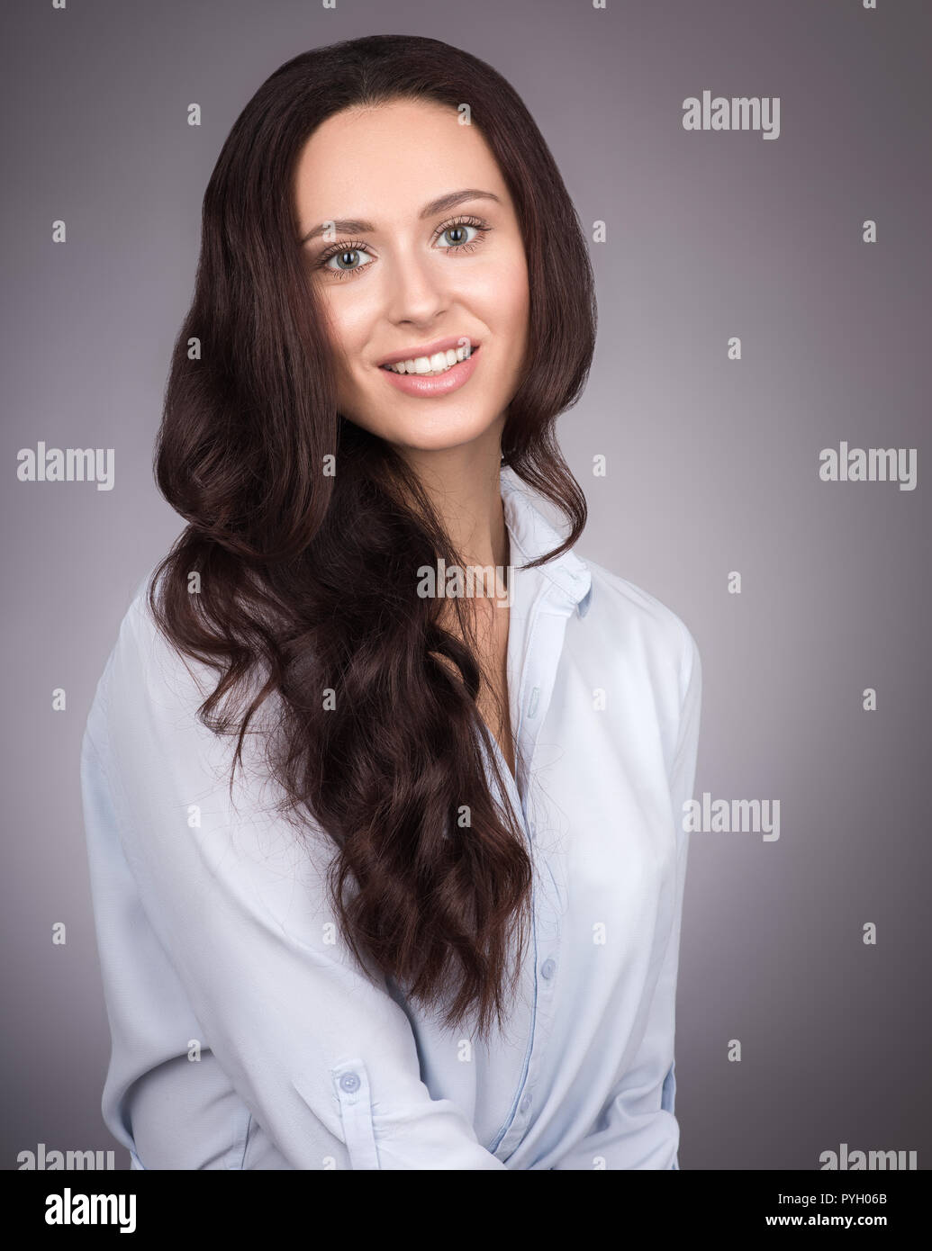 Natural Beauty Portrait Of A Young Woman With Long Wavy Hair On A