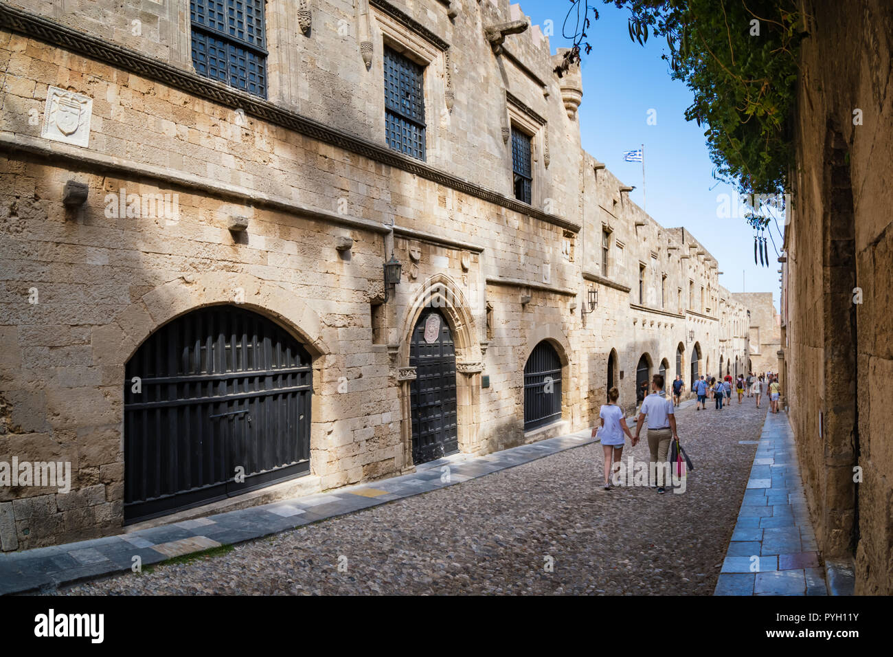 Couple walking down the street of knights (Ippoton) in City of Rhodes (Rhodes, Greece) Stock Photo