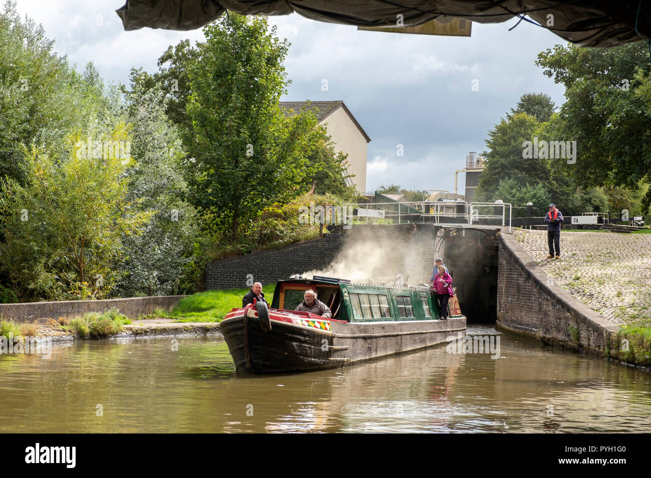 Narrow boat with coal fire heating on the Trent and Mersey Canal in Middlewich Cheshire UK Stock Photo