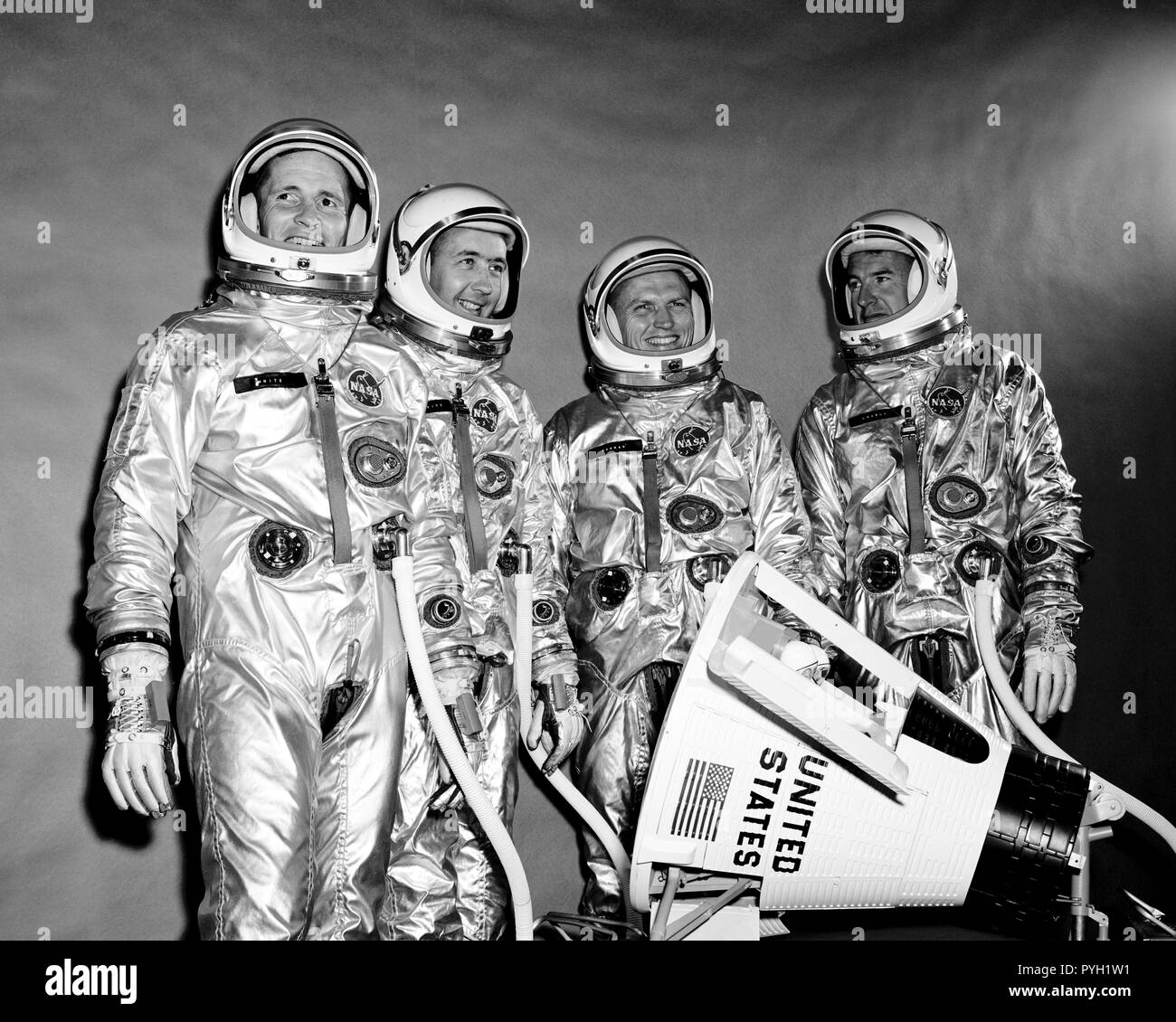 (10 Sept. 1964) --- View of the Gemini-4 prime crew and backup crew in pressure suits. They are standing around a model of the Gemini spacecraft. From left to right are astronauts Edward H. White II, pilot; James A. McDivitt, command pilot; Frank Borman and James A. Lovell Jr., backup crew. Stock Photo