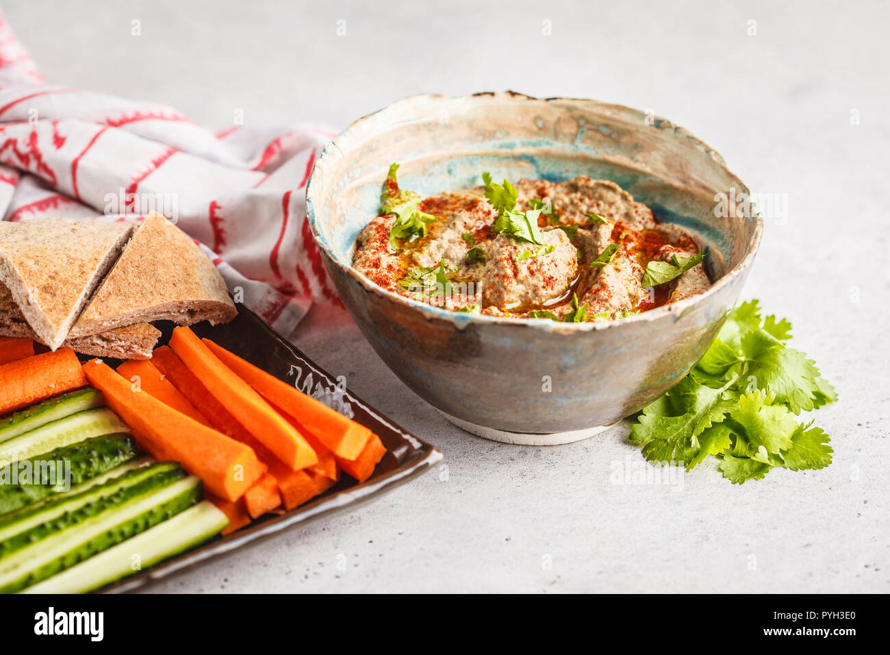 Babaganoush in a plate on white background. Plant based diet, vegan food concept. Stock Photo
