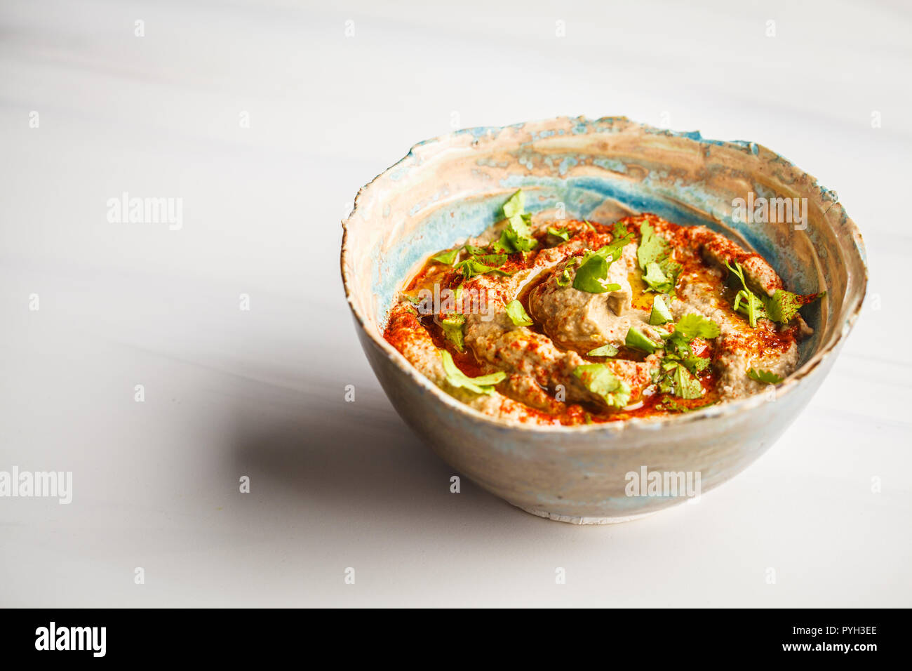 Babaganoush in a plate on white background. Plant based diet, vegan food concept. Stock Photo