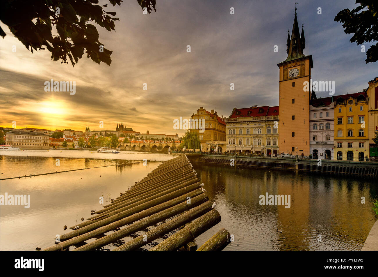 Vltava river from Smetana embankment, Lavka riverbank, Old Town Water Tower. In the backgroun Charles Bridge and Hradcany hill. Stock Photo