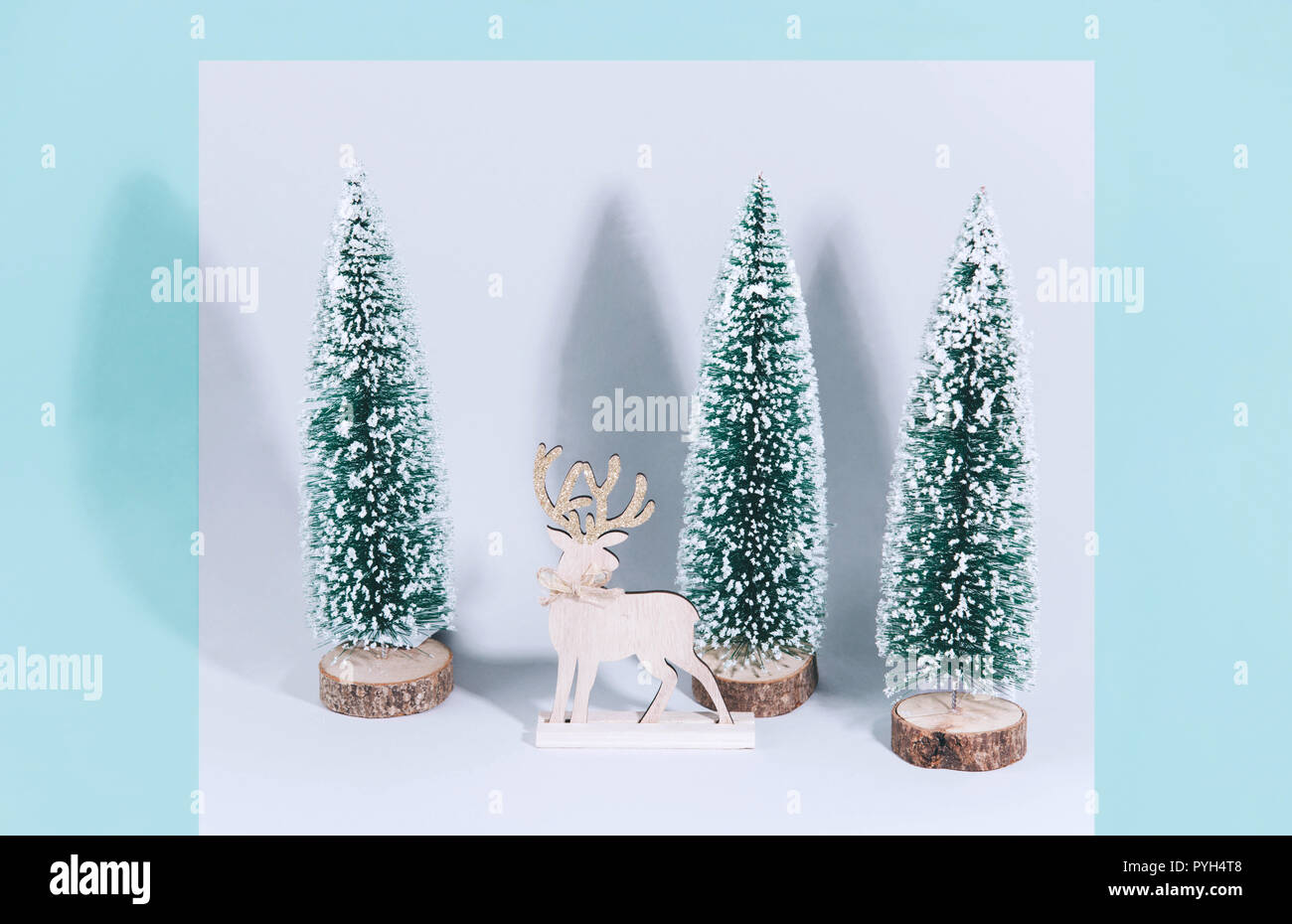 Christmas wooden tree with reindeer over light blue background Stock ...