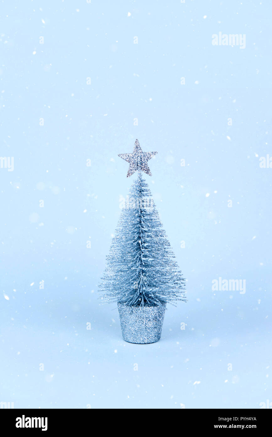 Christmas tree over light blue background Stock Photo - Alamy