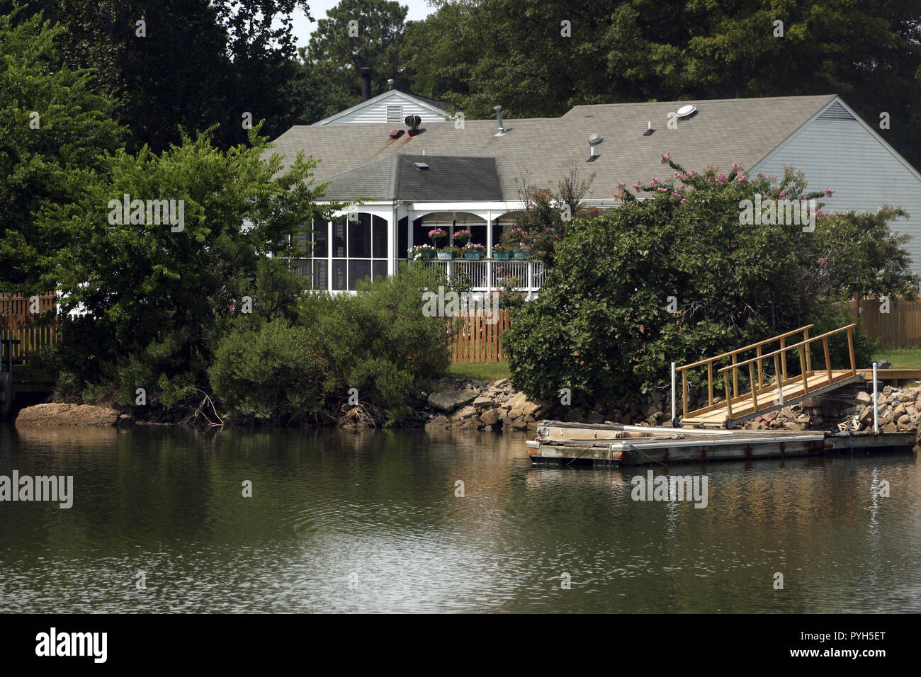 House by the lake with boat ramp Stock Photo Alamy
