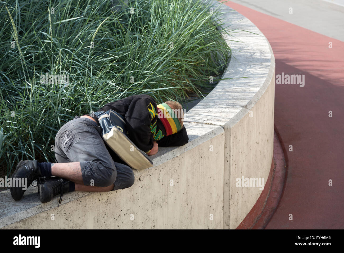 Poznan, Wielkopolska, Poland - Alcoholic homeless person sleeps out his intoxication Stock Photo