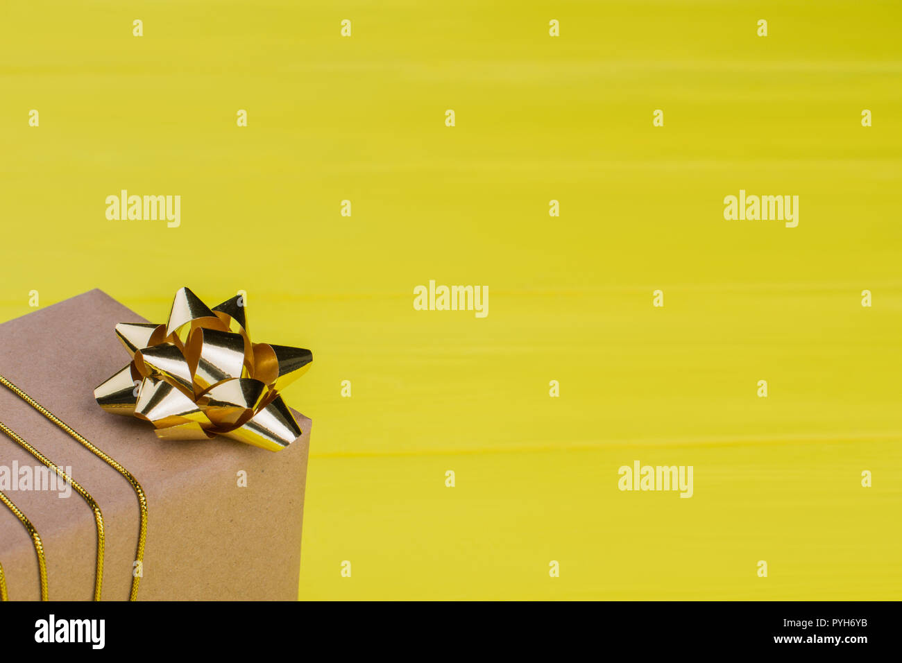 Download Kraft Gift Box On Yellow Background Yellow Wood Close Up Stock Photo Alamy PSD Mockup Templates