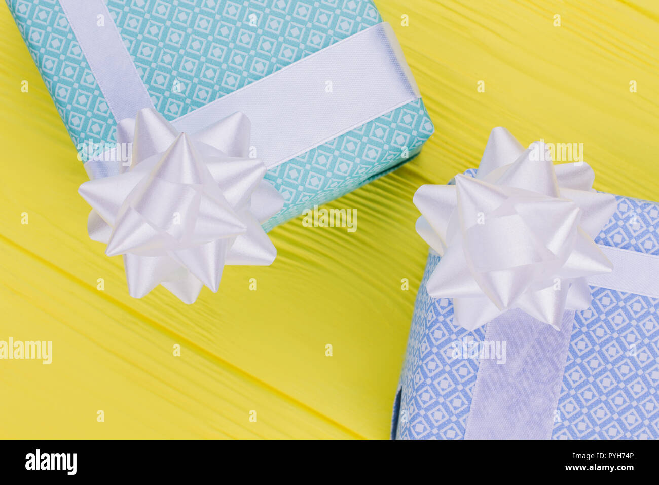 Download Beautiful Gift Boxes On Yellow Background Present Boxes Wrapped In Delicate Paper With White Bow On Vibrant Background Stock Photo 223498934 Alamy PSD Mockup Templates