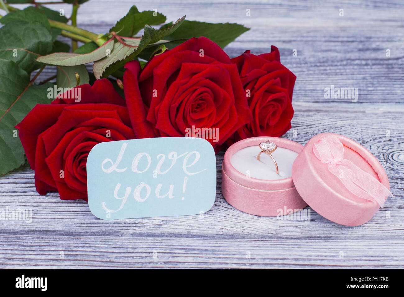 Roses, golden ring and love message. Romantic background with blooming  flowers, diamond ring and card with inscription love you. Saint Valentines  Day Stock Photo - Alamy