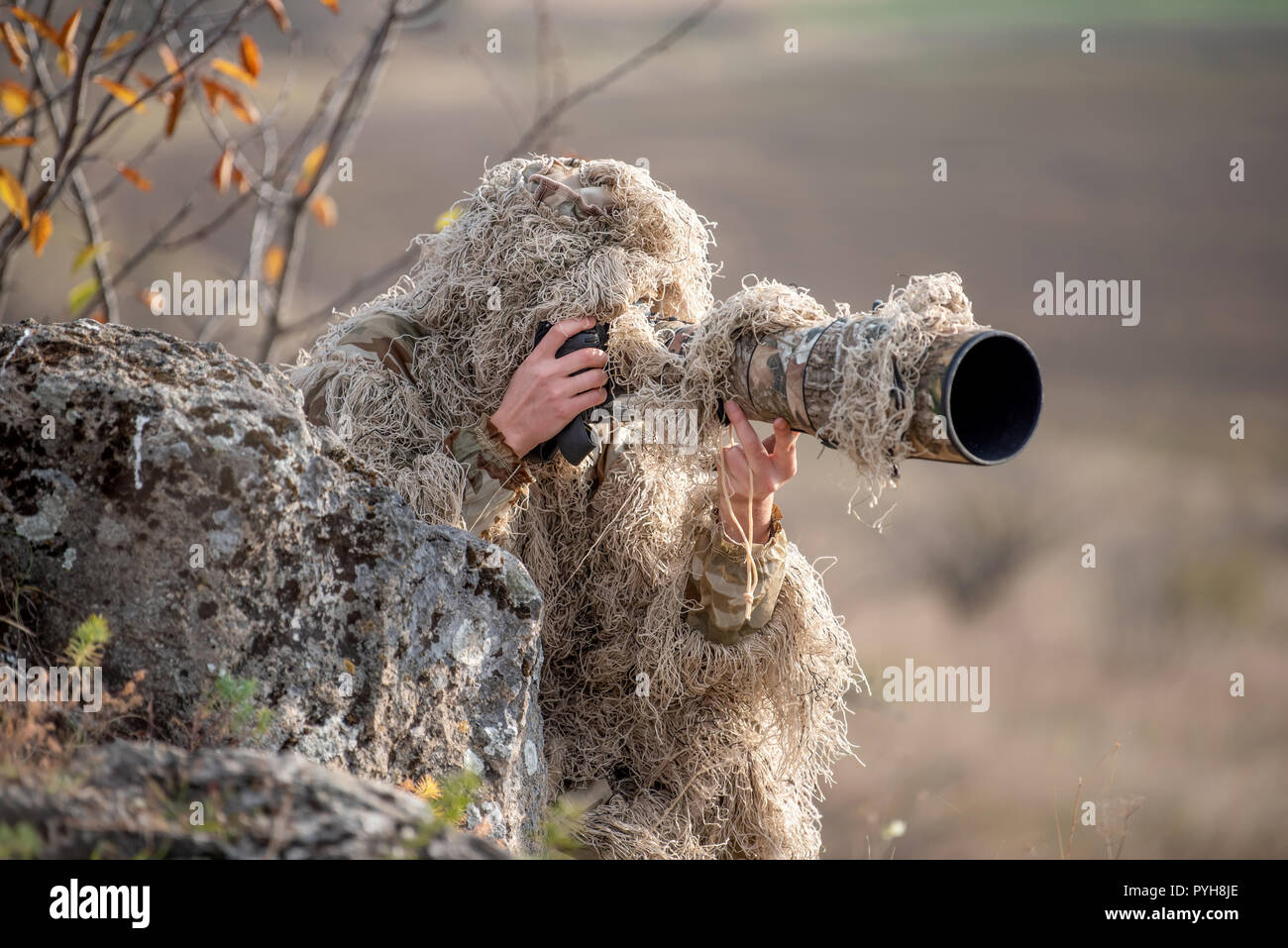 Wildlife Photographer In The Summer Ghillie Camouflage Suit Working In The  Wild Stock Photo, Picture and Royalty Free Image. Image 149757705.