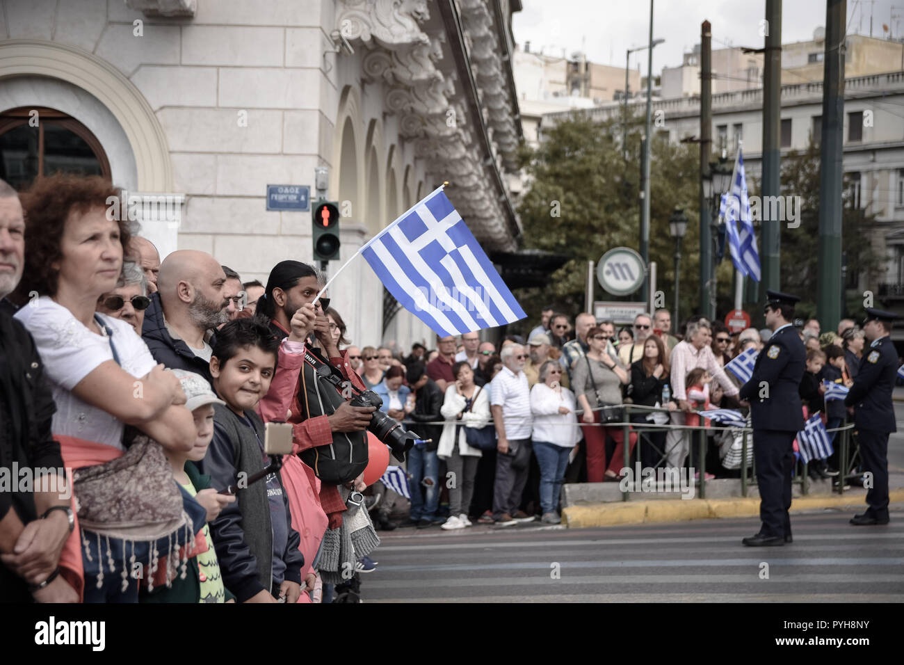 People are seen watching the student parade during the celebrations. The national 'Oxi (No) Day' commemorates the rejection by Greek Prime Minister Ioannis Metaxas of the ultimatum made by the Italian dictator Benito Mussolini on 28 October 1940 during World War II.  It is celebrated yearly by Greek communities around the world, in Greece and Cyprus. After World War II it became a public holiday in Greece and Cyprus and the event is commemorated every year with military and student parades. On every anniversary, most public buildings and residences are decorated with Greek flags. Stock Photo