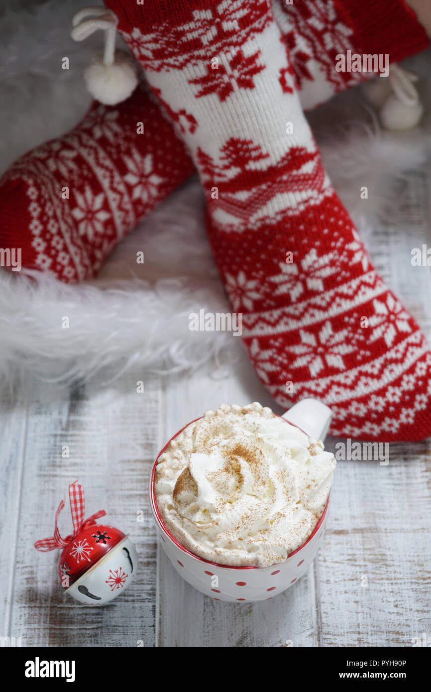 Woman in Christmas socks and hot chocolate drink. Winter holiday Xmas and New Year concept Stock Photo