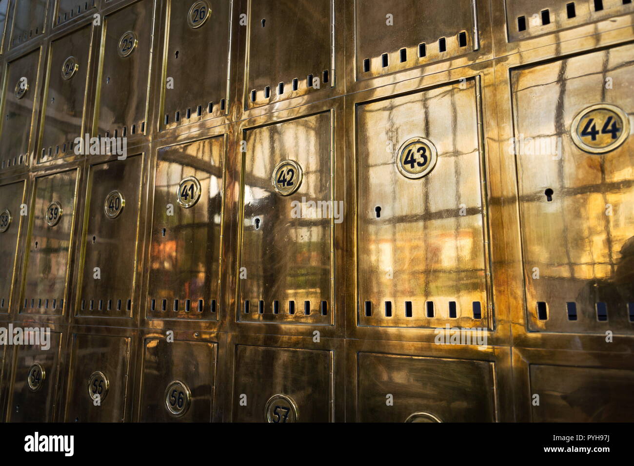 Closed golden post office boxes with numbers in circles, banking