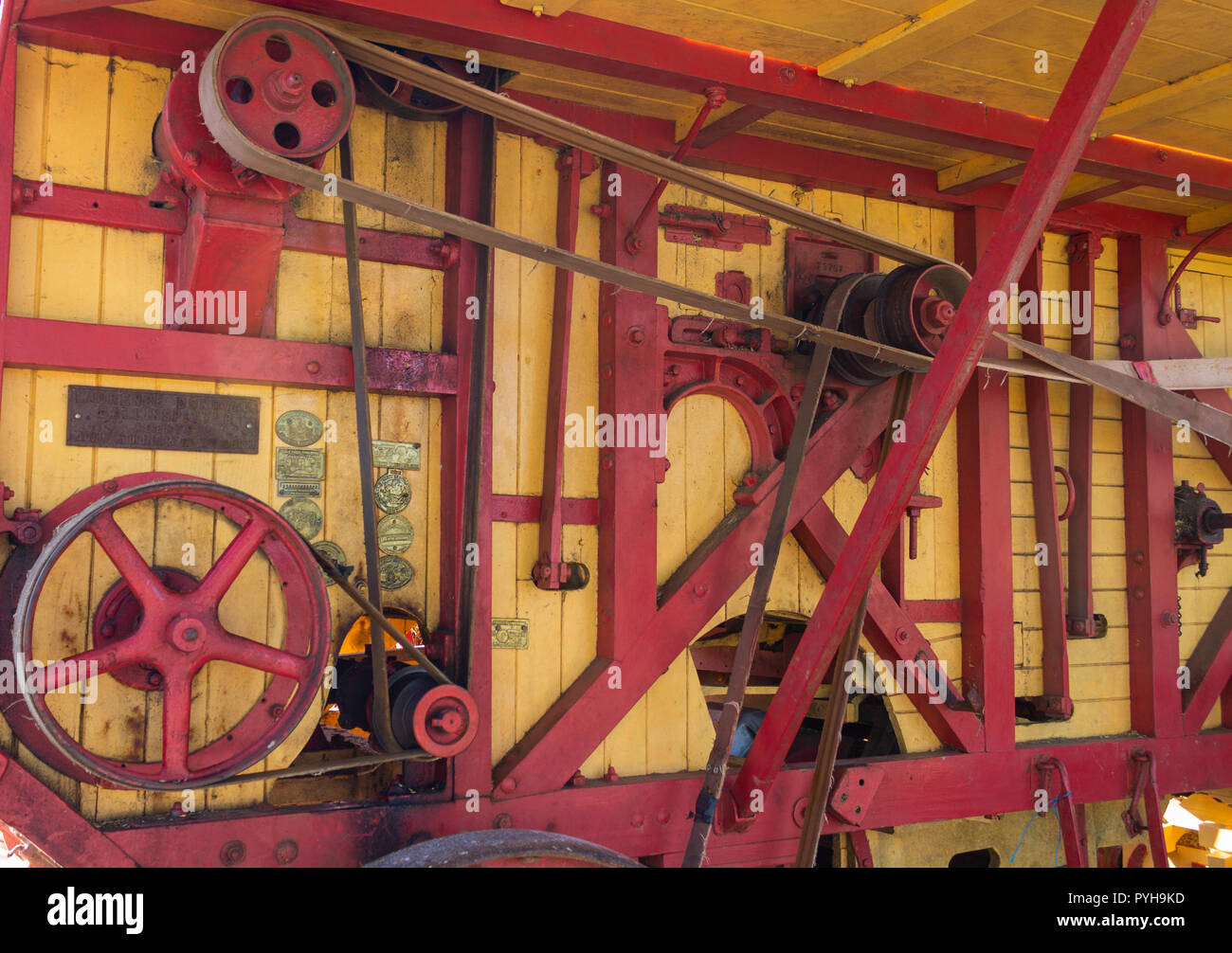 leather drive belts and pulley system on a vintage threshing machine. Stock Photo