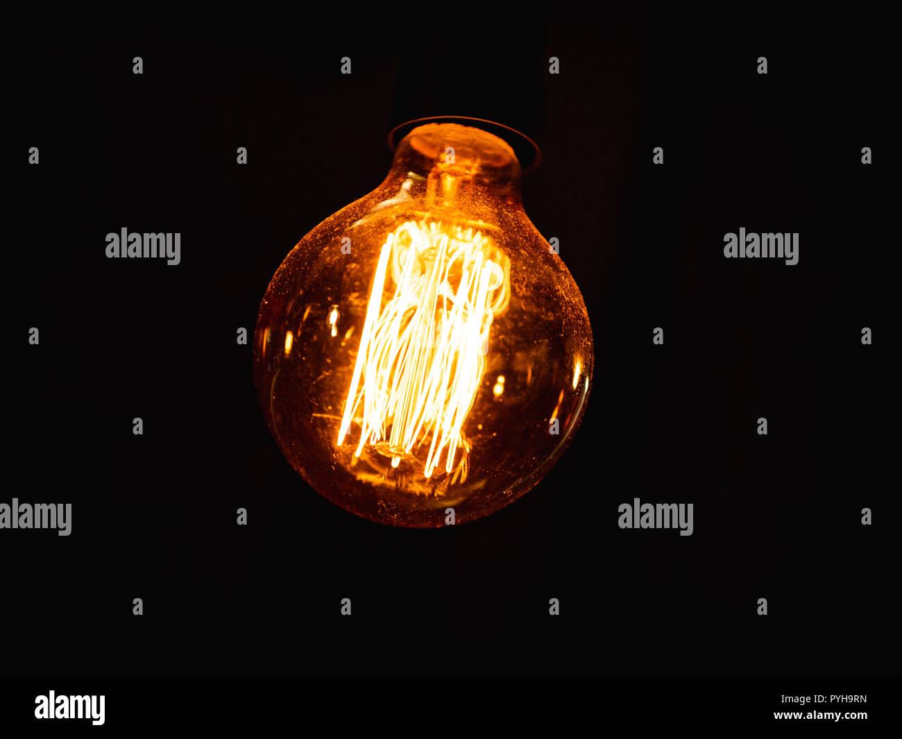 vintage lightbulb with dust on it against  dark background Stock Photo